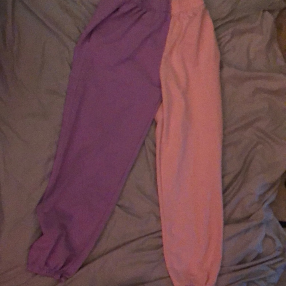 Half purple half pink sweats one flaw is a rip at the bottom